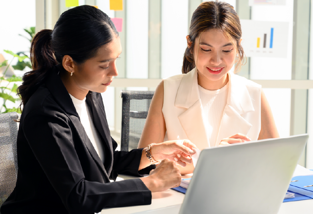 Two women discussing in front of a computer